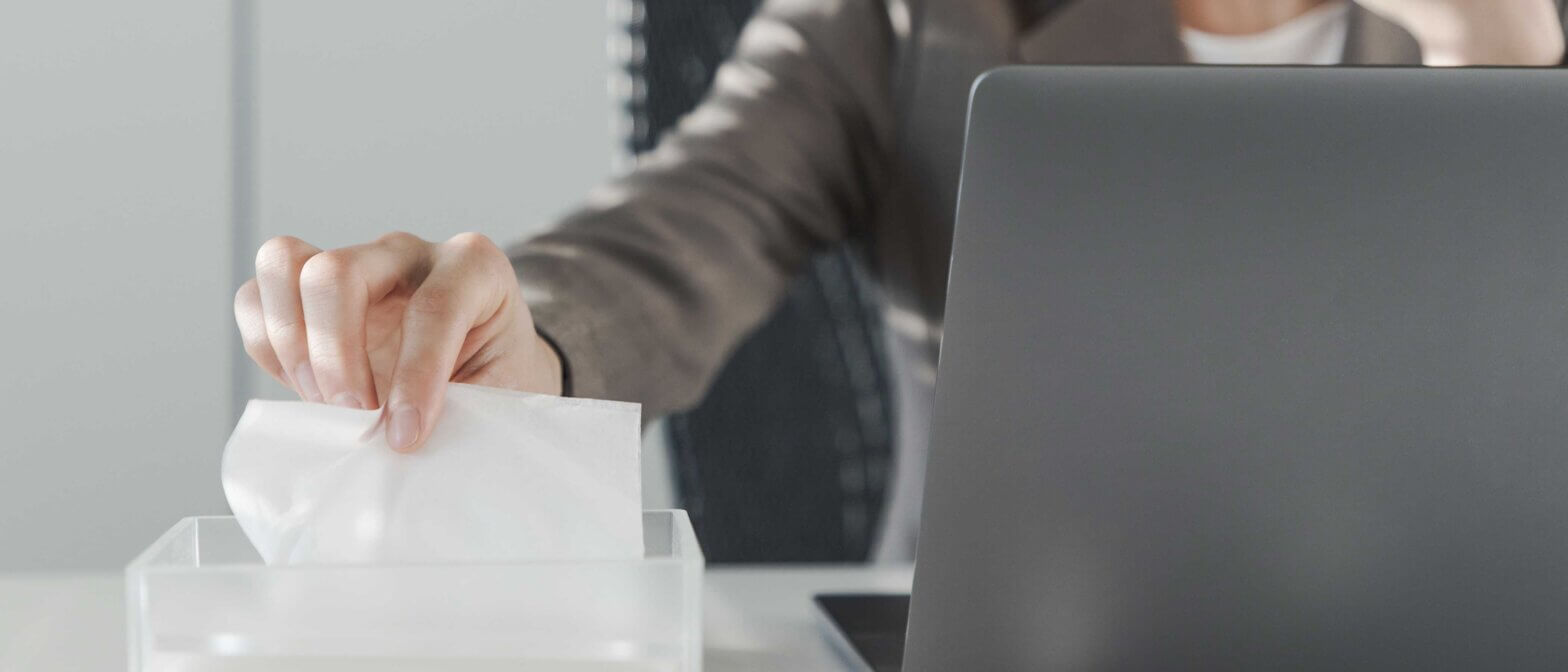 Employee pulling tissue out of box while working