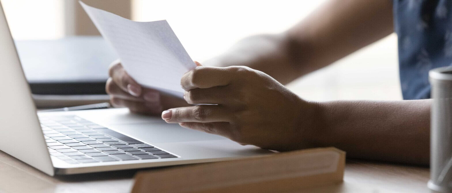Person reviewing a revised offer letter after being recalled from furlough