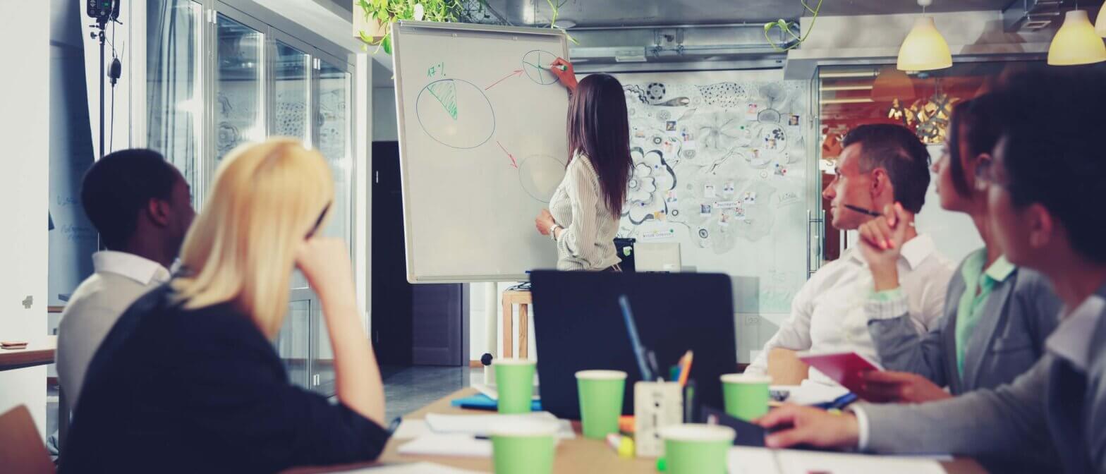 Businesswoman explains graph in a meeting