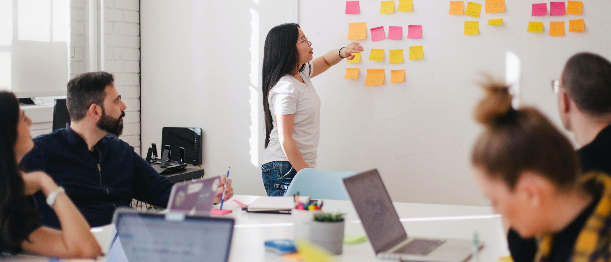 Team of employees collaborating during in-person meeting