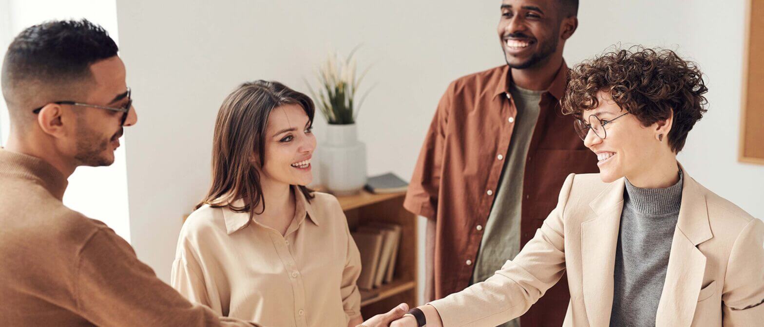Team of employees greeting eachother
