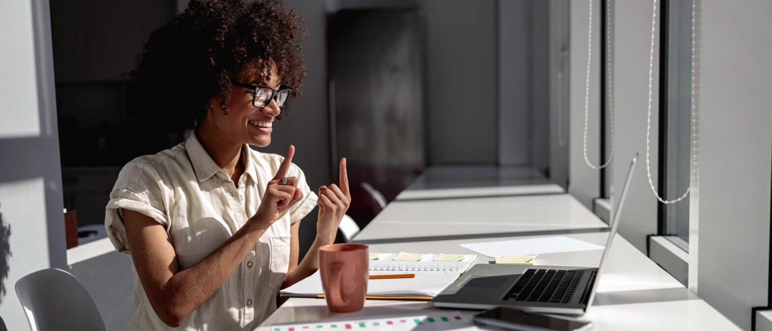 Employee communicating with sign language during virtual meeting