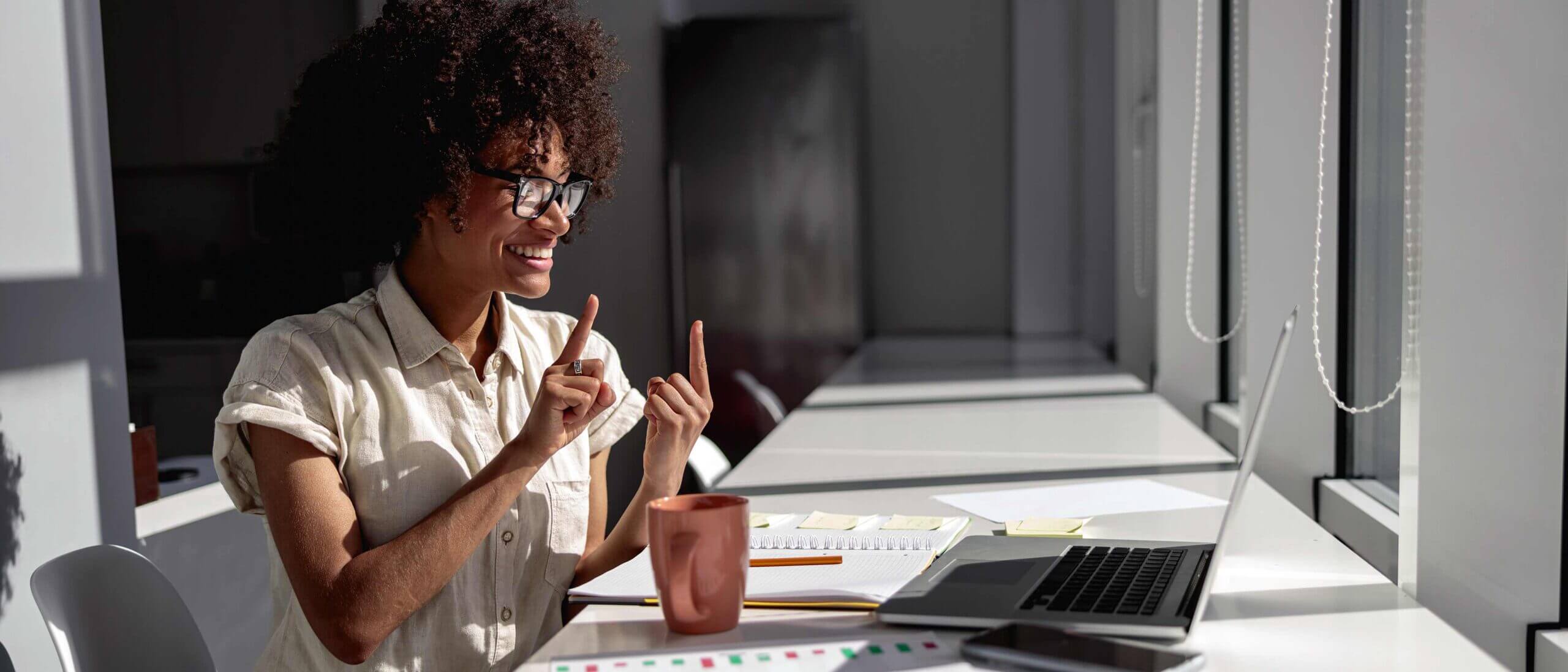 Employee communicating with sign language during virtual meeting