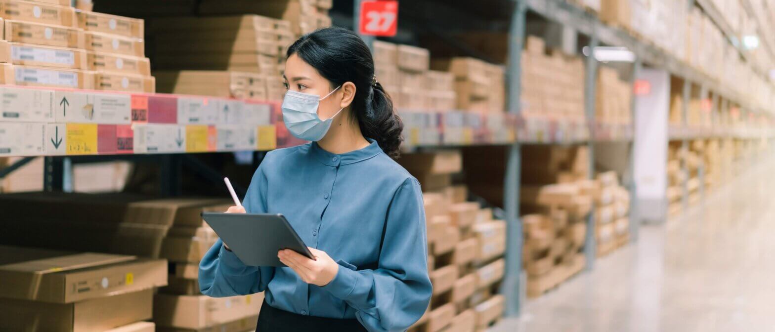 Masked woman taking inventory