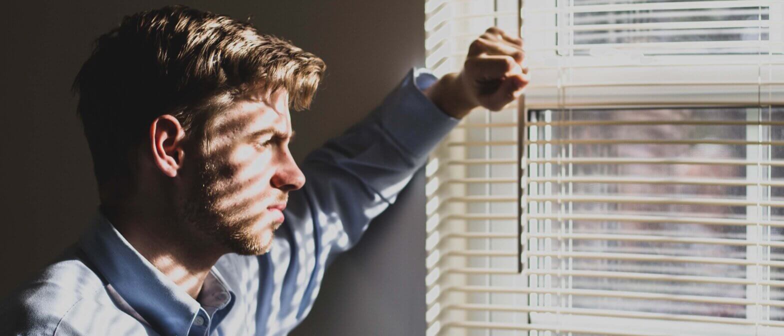 A stressed employee looks out the window