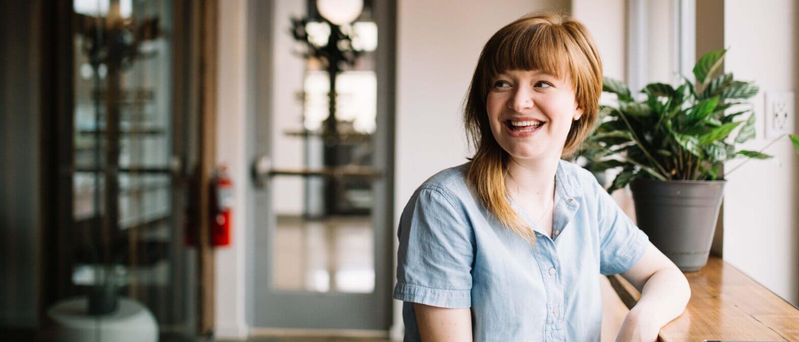 Person smiling and looking across the room
