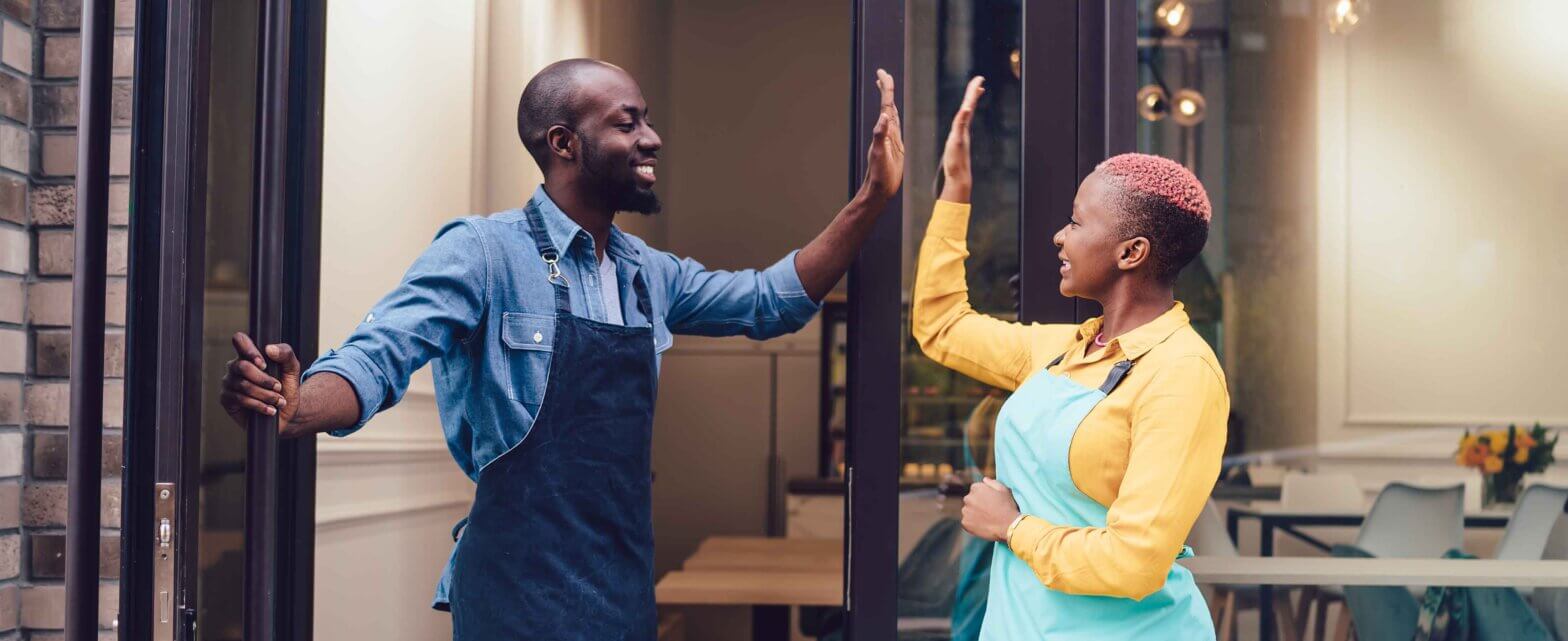 Two employees about to do a high five