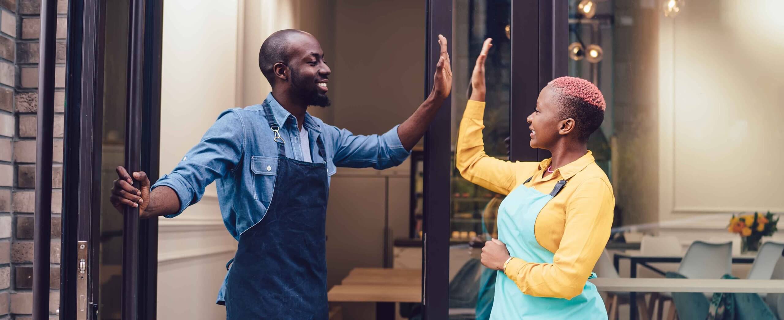 Two employees about to do a high five