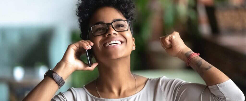 Woman on phone celebrating