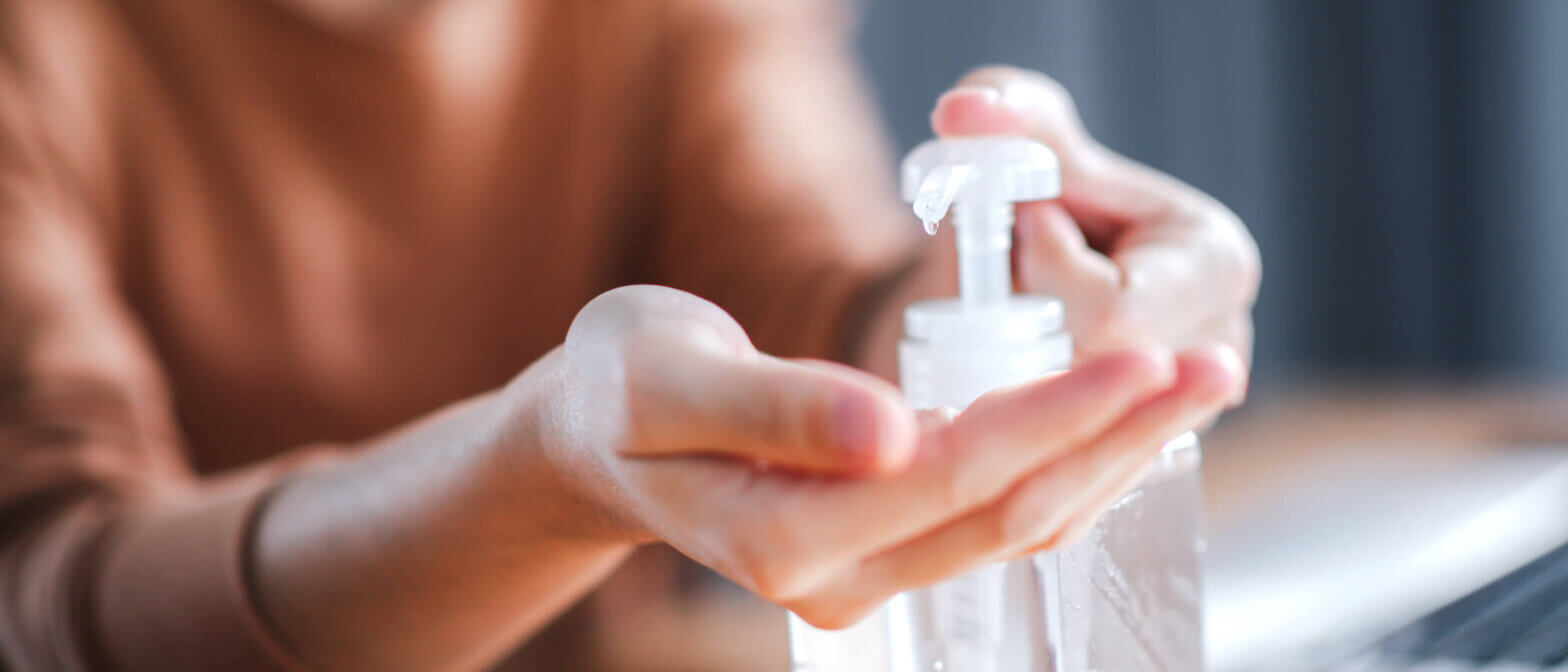 Employee using hand sanitizer in the workplace
