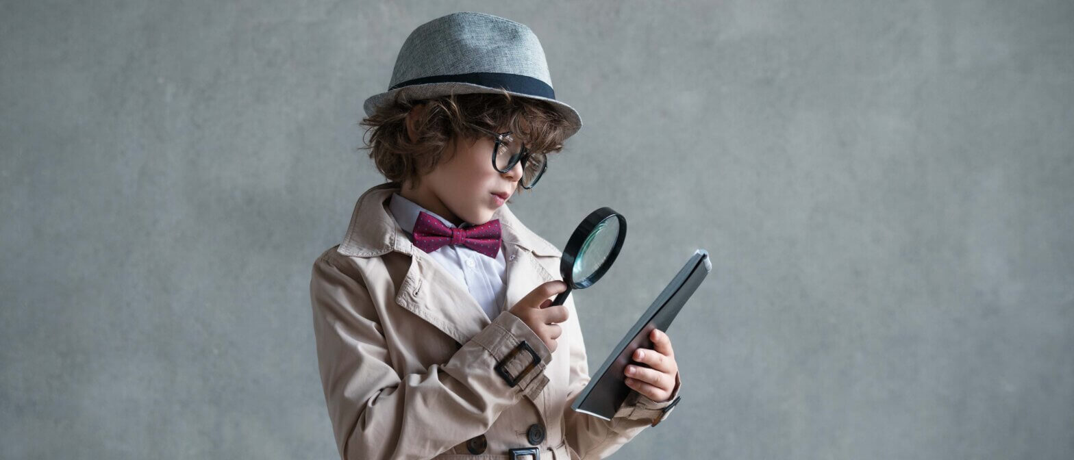 Little detective with a magnifying glass