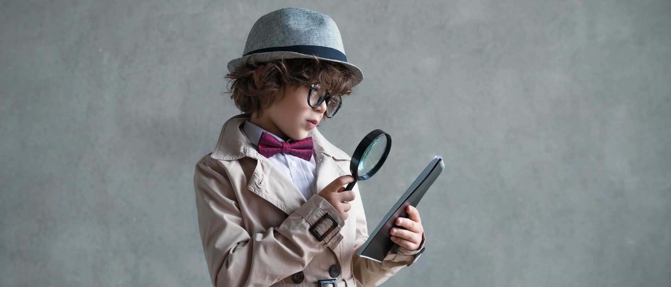 Little detective with a magnifying glass